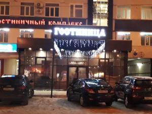 トリヤッチにあるGostinichnyi Kompleks Lada-Voskhodの夜間の建物の前に駐車した車2台