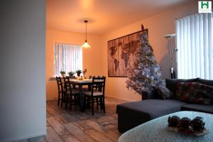 a living room with a christmas tree and a table at Reydarfjordur Apartment in Reyðarfjörður