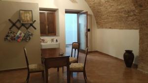 a kitchen with a table and chairs in a room at Palazzo Scelzi in Aliano