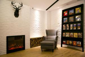 a living room with a chair and a fireplace at York Hotel in Taipei