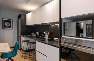 a kitchen with a stove top oven and a microwave at The Onyx Apartment Hotel in Cape Town
