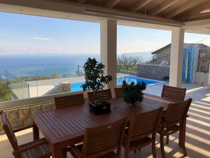 - une salle à manger avec une table et une vue sur l'océan dans l'établissement Studio Apartments Santa, à Marčići