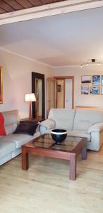 a living room with a couch and a coffee table at Soldeu Paradis Soldeu in Soldeu