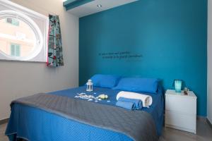 um quarto azul com uma cama com paredes azuis em Casa Zefiro em Pozzallo