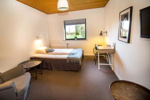 Ένα ή περισσότερα κρεβάτια σε δωμάτιο στο Dalby Hotel