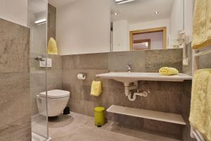 a bathroom with a toilet and a sink at Arvenhof in Serfaus