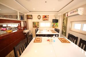 a dining room with a table and chairs in a restaurant at Le Emerald Residency in Tambaram