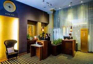 a tokyo office with two people sitting at desks at Grand Hotel Boutique in Rzeszów