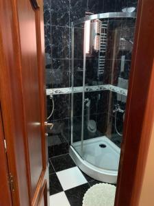 a bathroom with a shower with a glass door at Rooms Sanja in Kolašin