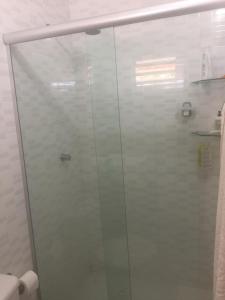 a shower with a glass door in a bathroom at Vista pro mar maravilhosa,Tibau-RN - INNOVA in Tibau