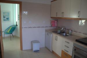 a kitchen with a sink and a counter top at Ericeira Sunset Apartment in Ericeira