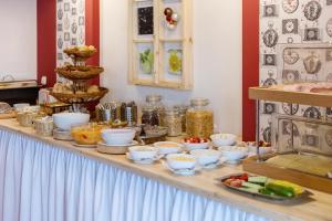 a buffet with bowls of food on a table at Hotel Aquamarin in Bad Mitterndorf