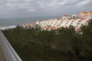 a row of houses on a hill next to the ocean at Ericeira Sunset Apartment in Ericeira