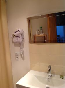 a bathroom with a phone on the wall next to a sink at Gîte Le Colombier de la Lanterne in Vannecrocq