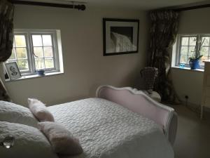 a bedroom with a bed with teddy bears on it at Castle Mill Bed and Breakfast in Dorking
