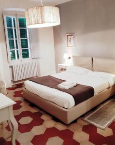 a bedroom with a large bed in a room at Toselli Suite Apartment in Pisa