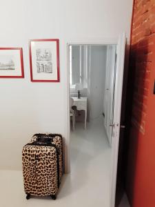 a room with a suitcase and a door and a table at Toselli Suite Apartment in Pisa