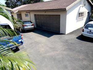 a garage with two cars parked in front of it at Home Away From Home Pinetown in Pinetown