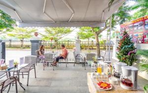 a couple sitting at a table on a patio at Horizon 2 villa in Hoi An