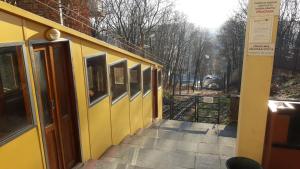 a yellow building with a walkway next to a building at KaunasInn - AM in Kaunas