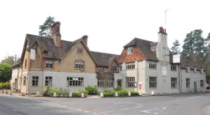 a large white building on the side of a street at Bel And The Dragon-Churt in Farnham