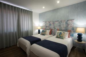 Tempat tidur dalam kamar di Casa d'Avó Guesthouse and Apartment