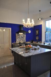 a kitchen with blue walls and a large counter top at Aberley House in Liverpool