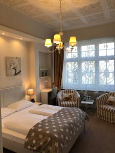 Hotel Fresena im Dammtorpalais في هامبورغ: غرفة نوم بسرير كبير وكرسيين