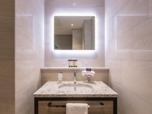 a bathroom with a sink and a mirror at Grand Central Hotel Belfast in Belfast