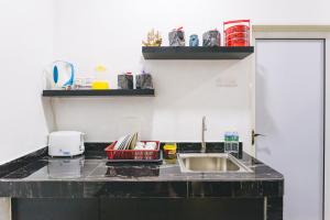 a kitchen with a sink and a counter top at Jia Residence in Malacca