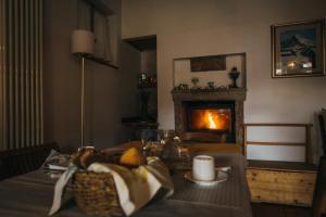 a living room with a fireplace and a table with a candle at B&B Pedelmont in Mezzocorona