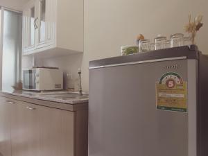 a kitchen with a refrigerator with a sign on it at Dcondo Kathu Patong Phuket by Suna in Kathu