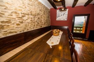 a dining room with a table and a stone wall at MAS NOU in Cinctorres