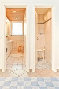 a bathroom with a shower and a sink and a toilet at Apartments Hauskaernten in Velden am Wörthersee
