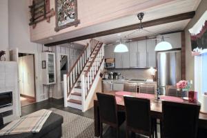 a kitchen and dining room with a table and a staircase at Levin Rölli - Apartment 4 in Levi