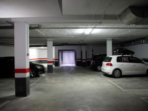 a parking garage with two cars parked in it at Flats Friends Soho Suites in Valencia