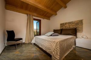 a bedroom with a bed and a chair and a window at Villa Thalia in Castellammare del Golfo +14 photos