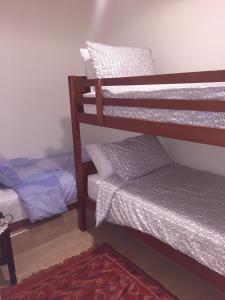 a room with two bunk beds and a rug at Marina Apartment Agadir in Agadir