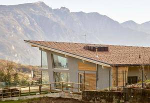a house with a mountain in the background at Luxury Chalet Pinocchio in Brentonico