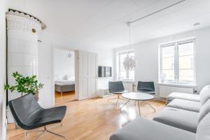 a living room with a couch and chairs and a table at City Apartments in Jonkoping in Jönköping