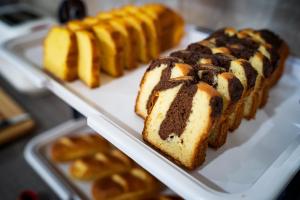 a white tray with several different types of bread at Hôtel La Rocade in Pamiers