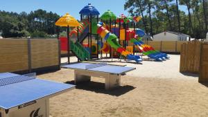 a playground with a play equipment in the sand at Camping Le California in Saint-Jean-de-Monts