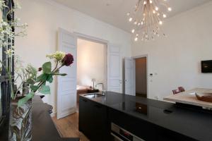 a kitchen with a black counter and a vase of flowers at Cap's House in Ghent