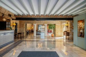 a living room with a stone wall and a ceiling at Parador de Carmona in Carmona