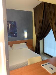Uma cama ou camas num quarto em Best Western Hotel Class Lamezia