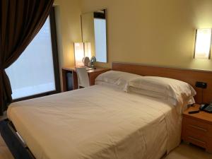 Uma cama ou camas num quarto em Best Western Hotel Class Lamezia