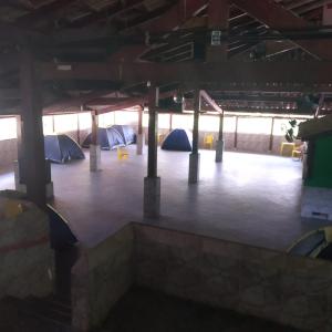 a room with tents and chairs in a building at Camping Monte Hermom in Ubatuba