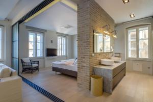 1 dormitorio con 1 cama y lavamanos en una habitación en Apartments Argemonia, en Mali Lošinj