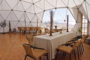 a room with tables and chairs in a tent at Kunza Kamanchacos in Punta de Choros