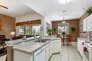 a kitchen with a sink and a living room at Olivia's Dream Villa on WindsorHills in Orlando